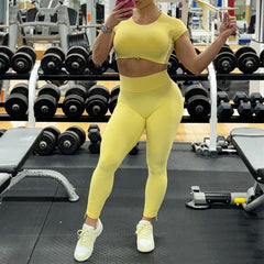 Person wearing a yellow athletic outfit in a gym setting