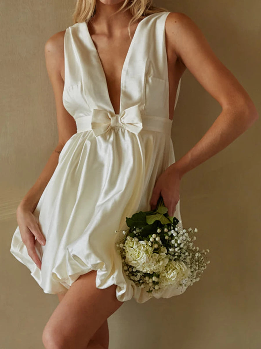 Woman in a white dress holding flowers