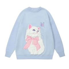 Light blue sweater with a white cat design wearing a pink bow 