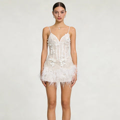 Woman wearing a white lace nightgown on a plain background