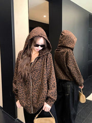 Person wearing a leopard print hoodie in front of a mirror.