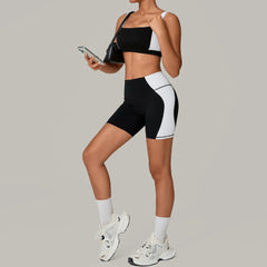 Person wearing black and white athletic outfit with sneakers