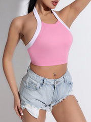 Person wearing a pink crop top and denim shorts