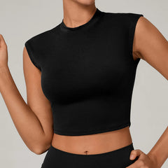 Person wearing a black sleeveless top against a neutral background