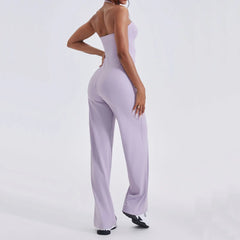 Person wearing a lavender jumpsuit on a white background