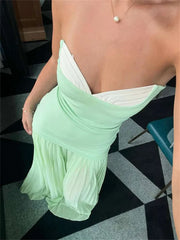 Women's green strapless maxi dress with pleated details.