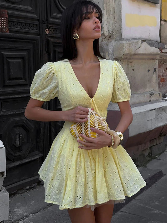 Women's yellow tie-up puff sleeve mini dress with a V-neck and A-line silhouette.

