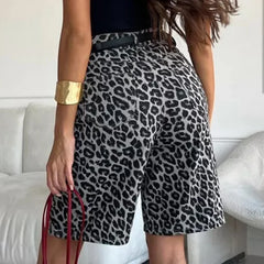Person wearing leopard print shorts with a blurred background