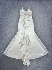 White satin dress with floral details on a textured gray background