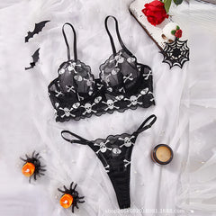 Women's lingerie set with skull embroidery and sheer mesh.