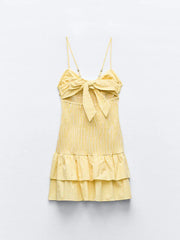 Yellow checkered dress with a bow detail on a white background
