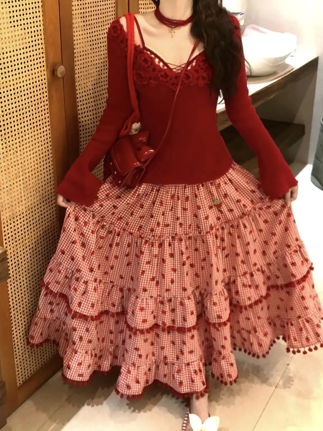 Women's red strawberry print tassel long skirt with tiered ruffles.

