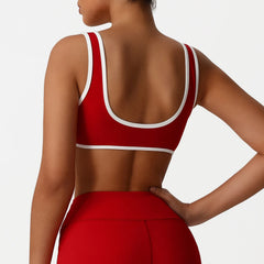 Red sports bra with white trim worn by a person back view