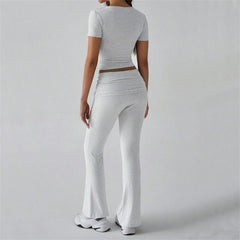 Person wearing a gray outfit with a top and pants - back view