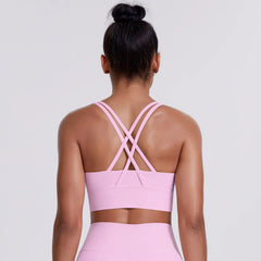 Person wearing a pink sports bra and leggings - back view