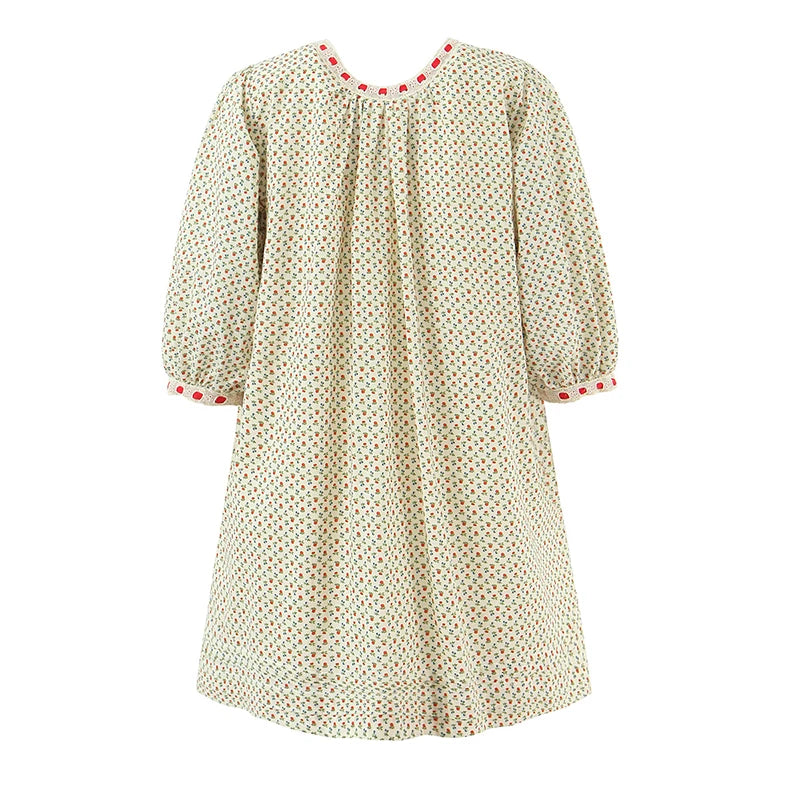 Beige dress with red accents on a white background