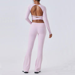 Person wearing a pink long-sleeve top and leggings set on a white background