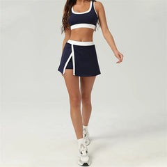 Woman wearing a navy sports outfit with white accents- full view