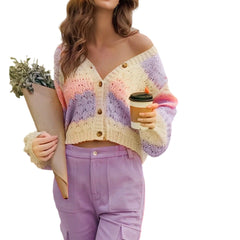 Woman wearing a colorful crochet cardigan holding a coffee cup and plant
