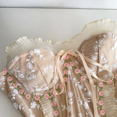 Embroidered lace fabric with floral patterns on a white background