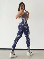 Person wearing a gray sports bra and blue tie-dye leggings 