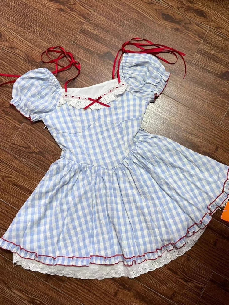 Blue and white checkered dress with red accents on a wooden floor