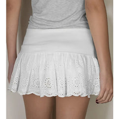White eyelet skirt worn with a gray top 