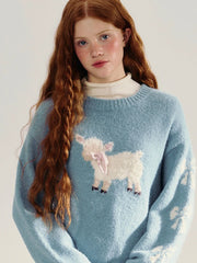 Girl wearing a blue sweater with a sheep design 
