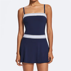 Navy blue dress with white accents on a plain background