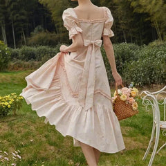 Women's floral dress with puff sleeves and a ruffled hemline.