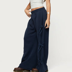 Navy blue wide-leg pants with tied sides worn by a person 
