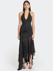 Black halter neck dress with sheer panels on a white background