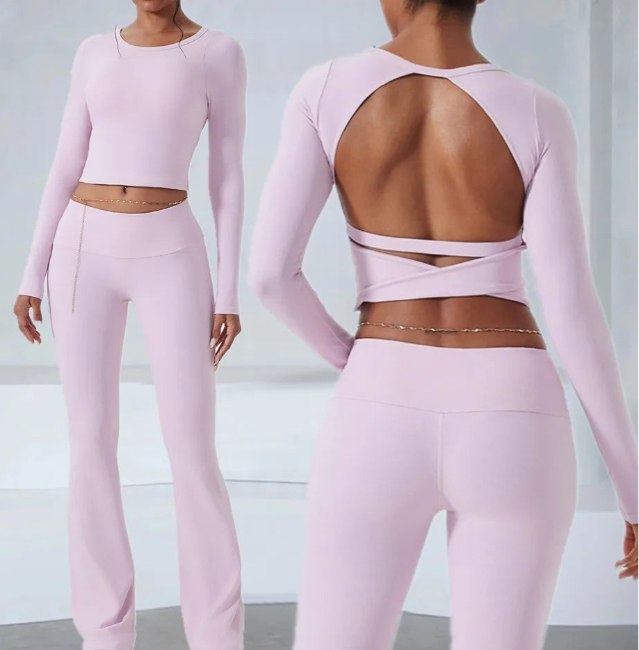 Pink athletic outfit with long-sleeve top and open-back design, shown from front and back.
