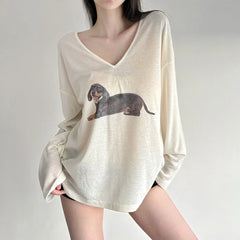 Beige long-sleeve shirt with dachshund graphic worn by a model 