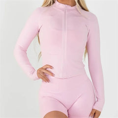 Pink long-sleeve top and shorts set on a white background