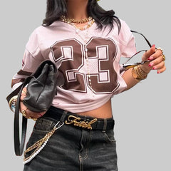 Person wearing a pink and brown sports jersey with number 23