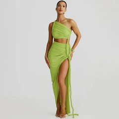 A one shoulder midi dress featuring cut out, rope detailing, and a slit, shown on model.
