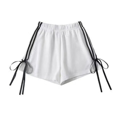 A pair of stylish shorts with a playful bow detail and a trendy striped print.