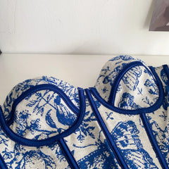 Blue and white patterned fabric with circular designs on a white background