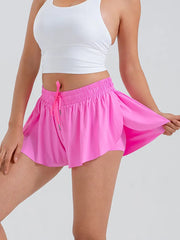 Person wearing a white crop top and pink skirt front view