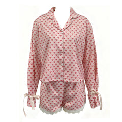 Pink pajama set with heart pattern on a white background