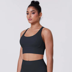Woman wearing a black sports bra and leggings-front view