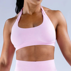 Person wearing a pink sports bra and leggings 