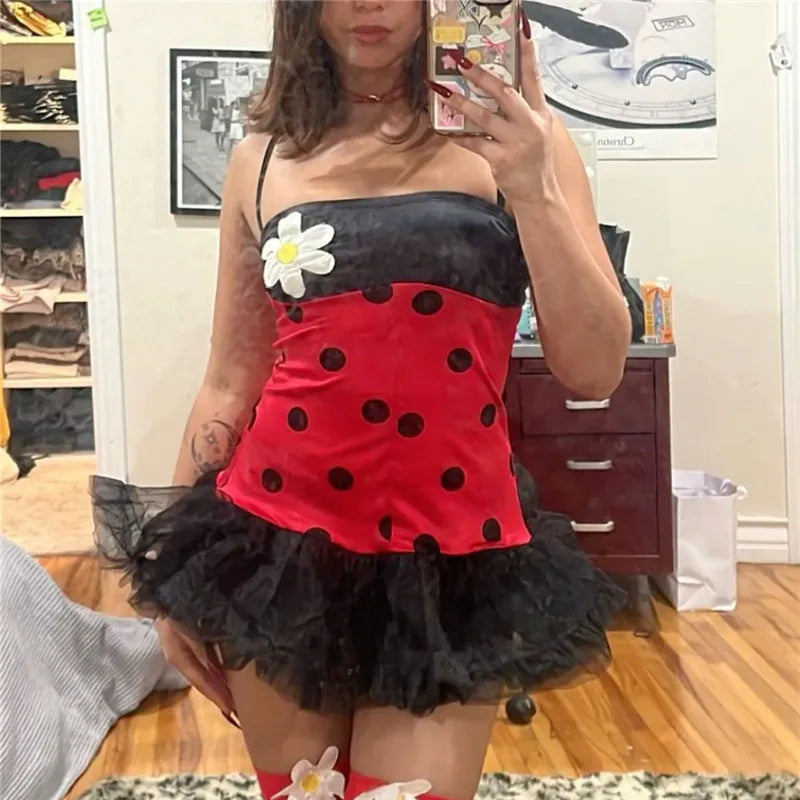 Woman in ladybug costume dress with polka dots, tutu skirt, and flower applique