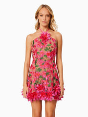 Woman wearing a pink floral dress on a white background