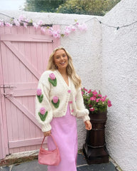 A woman wearing a 3D embroidered cardigan, highlighting how it adds a pop of personality to her outfit.