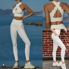 Woman wearing a white sports bra and leggings set with a scenic background.
