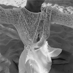 Close-up of a lace garment on a textured surface