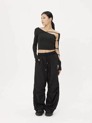 Person wearing a black outfit with cut-out details