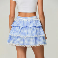 Blue checkered skirt with lace trim worn by a person 